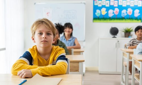 Group of student learn with teacher in classroom at elementary school. Attractive beautiful female instructor master explain and educate young children with happiness and fun activity at kindergarten.