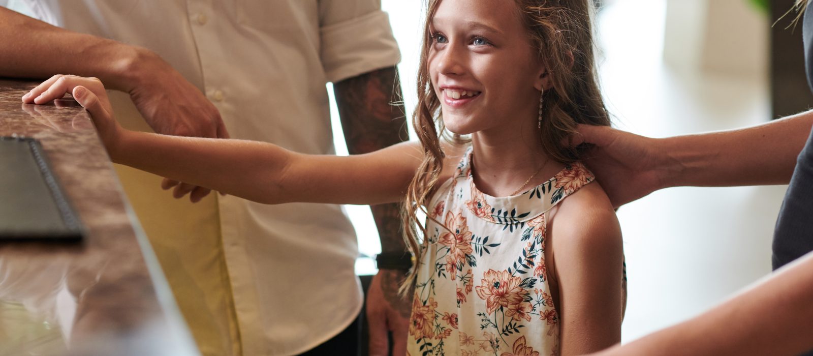 Preteen Girl Checking in at Hotel Reception