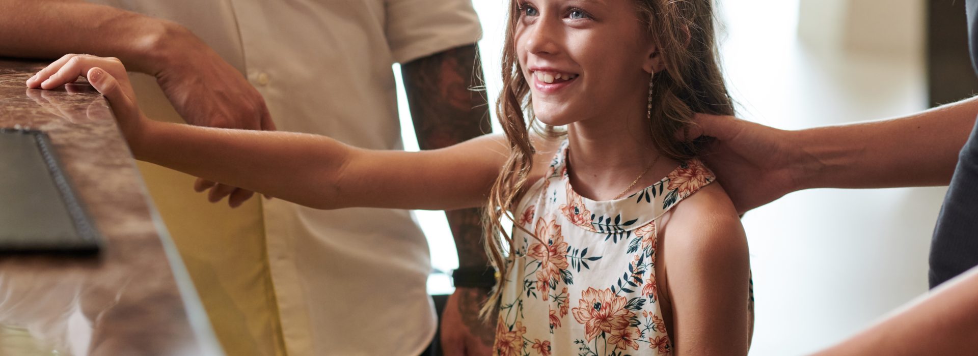 Preteen Girl Checking in at Hotel Reception