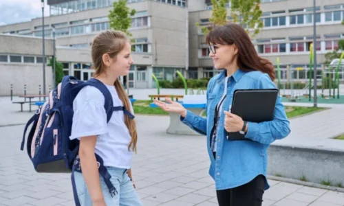 talking-teacher-and-schoolgirl-child-outdoor-scho-2024-12-08-02-03-11-utc-600x400-1