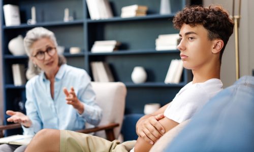 Sad teenager seeks help from a therapist in an office session focused on mental health. Teenager problem, mental health care concept