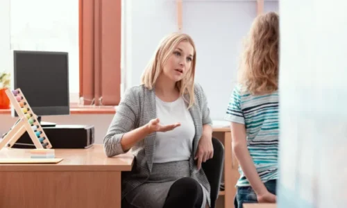 young-beautiful-teacher-sits-at-a-desk-in-class-an-2024-10-18-12-00-44-utc-600x400-1