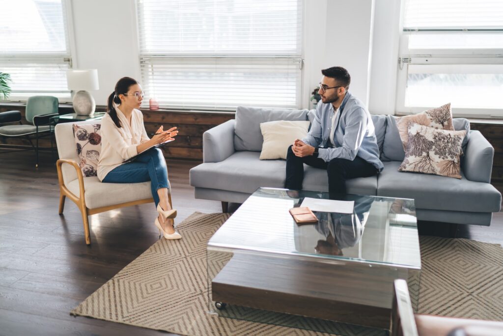 focused male psychotherapist talking to female cli utc scaled
