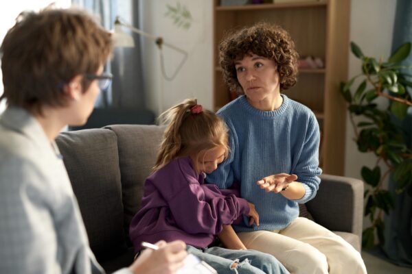woman talking to child psychologist at home utc scaled
