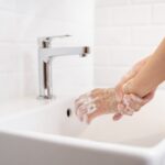 woman washing her hands in the bathroom at home utc scaled