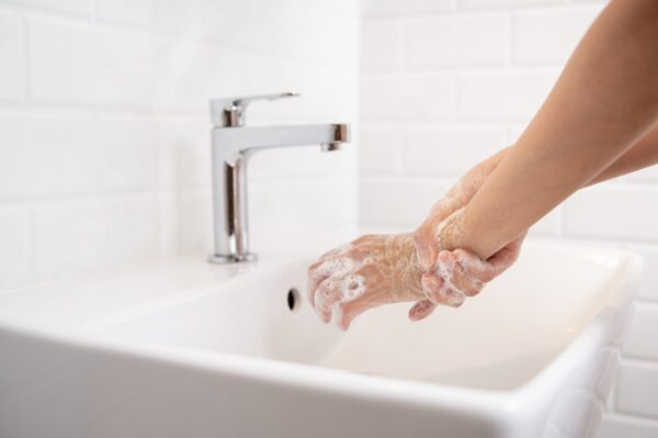 woman washing her hands in the bathroom at home utc scaled